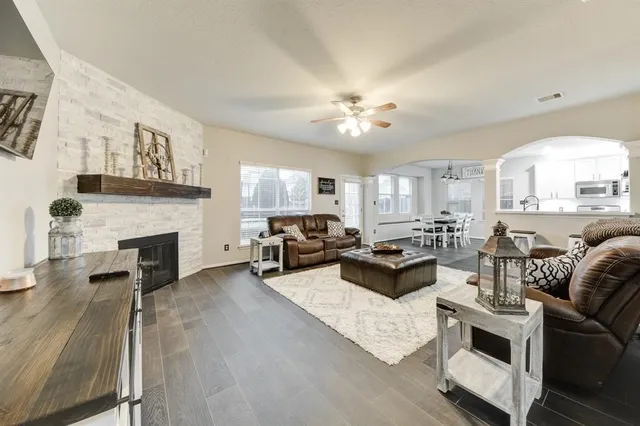 a living room with furniture fireplace and a window