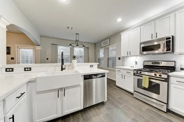 a kitchen with a sink stove and microwave