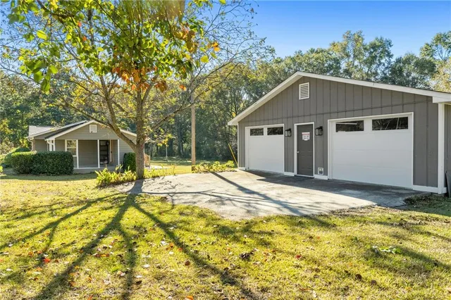 a house view with swimming pool in front of it