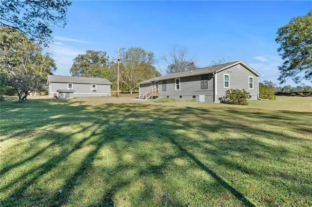 a front view of house with yard and green space