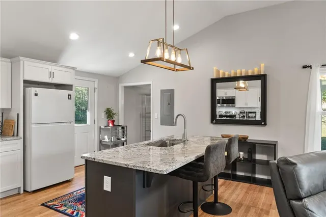 a view of a dining room with furniture wooden floor and a chandelier