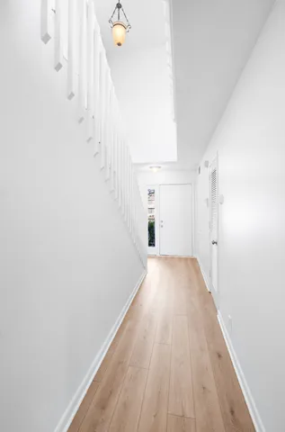 a view of a room with wooden floor