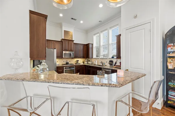 a kitchen with sink a window and cabinets