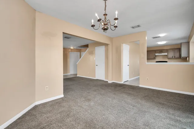 a view of a chandelier in big room and a livingroom