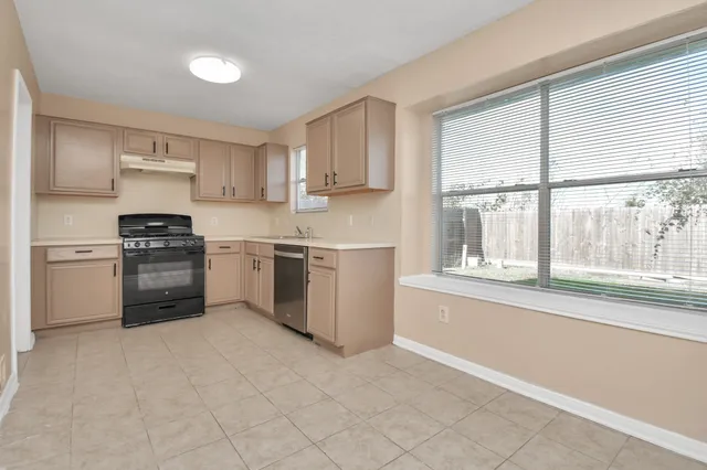 a kitchen with a stove a sink and a microwave