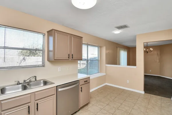 a kitchen with a sink cabinets and window
