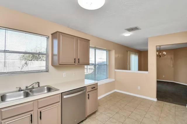 a kitchen with a sink cabinets and window