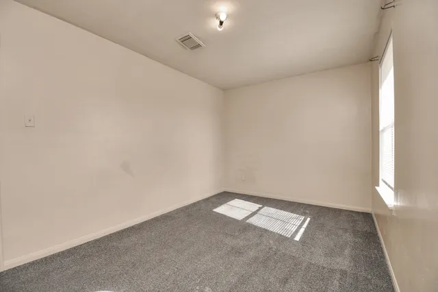 an empty room with a empty space and windows