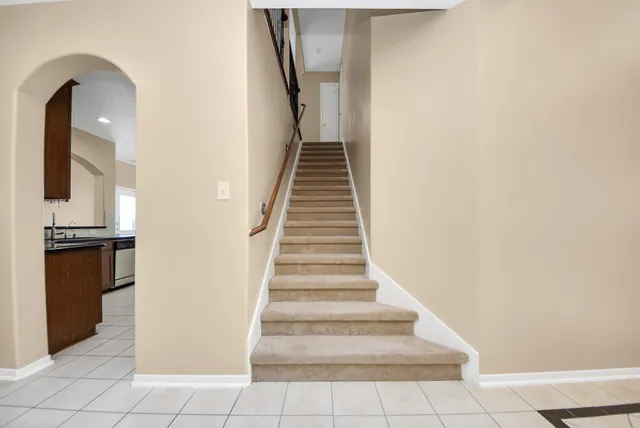 a view of a hallway with a sink and a mirror