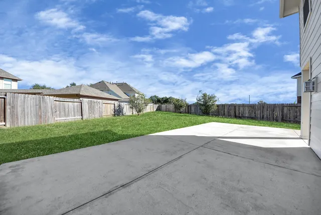 a view of house with garden and tall trees