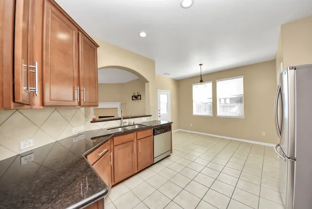 a kitchen with a sink cabinets and window