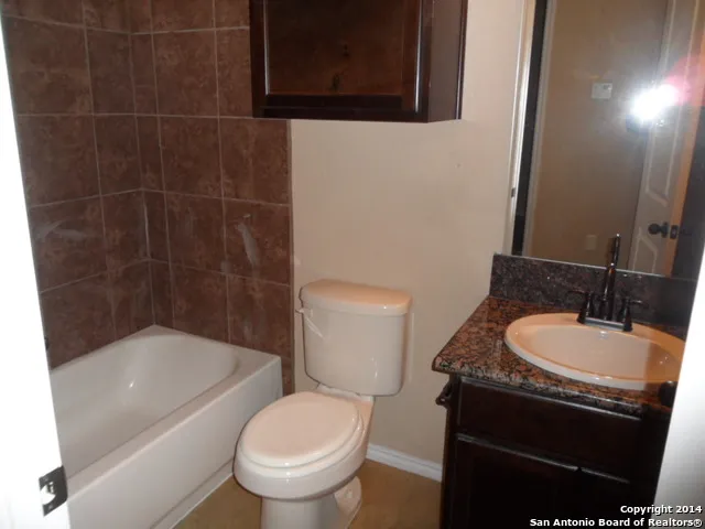 a white toilet sitting next to a bathroom sink