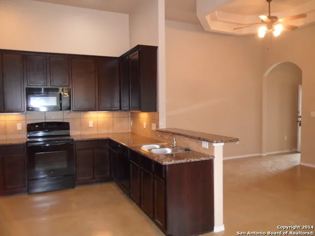 a kitchen with a sink and cabinets