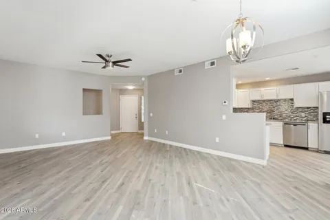 a view of a kitchen with wooden floor and a sink