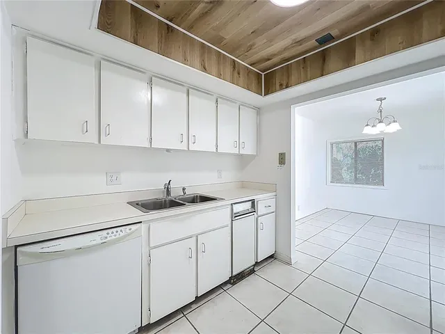 a kitchen with a sink cabinets and window