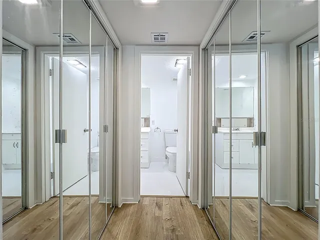 a bathroom with a toilet a sink a vanity and mirror