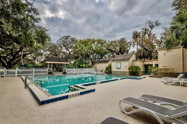 an aerial view of a house with a yard and lake view