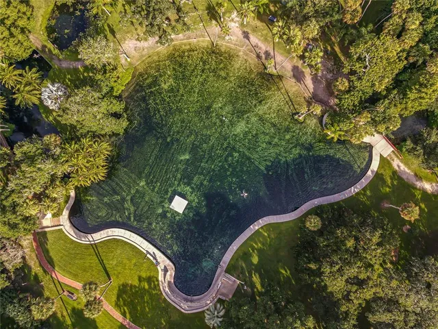 an aerial view of a house with swimming pool garden and patio