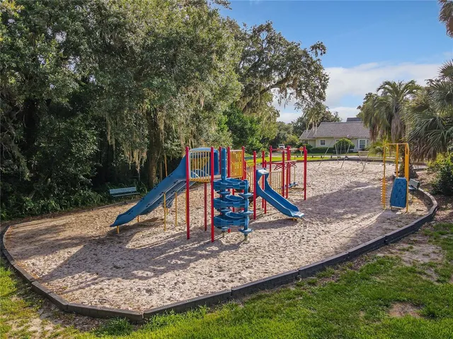 a view of a patio with table and chairs under an umbrella