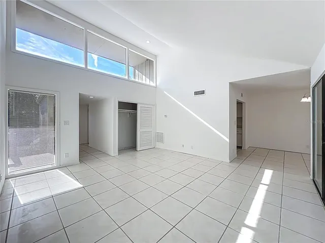 a view of a hallway with closet and bathroom