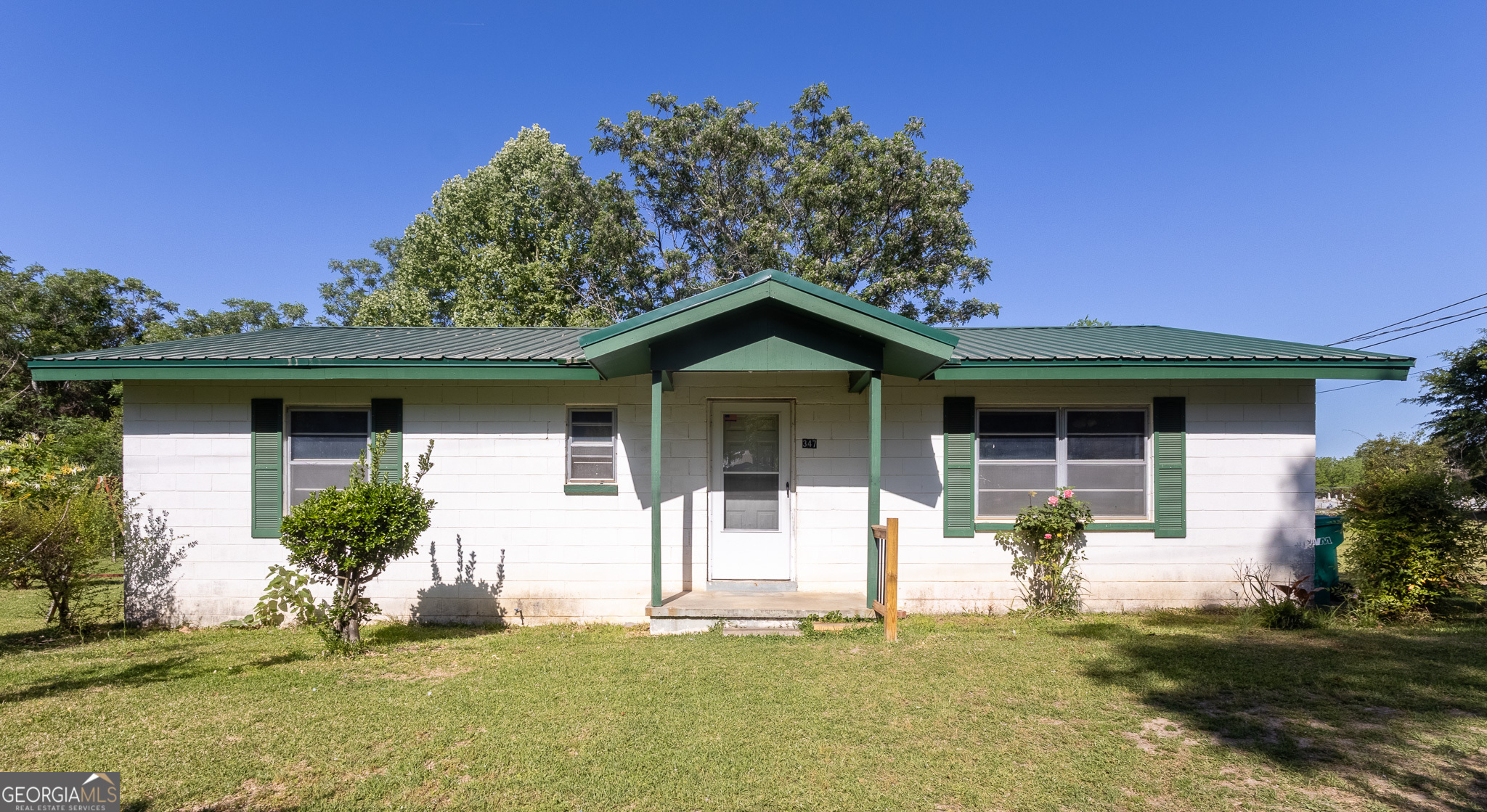 347 Peavy Street Unadilla, GA 31091 - Photo 1 of 15 a front view of a house with a yard