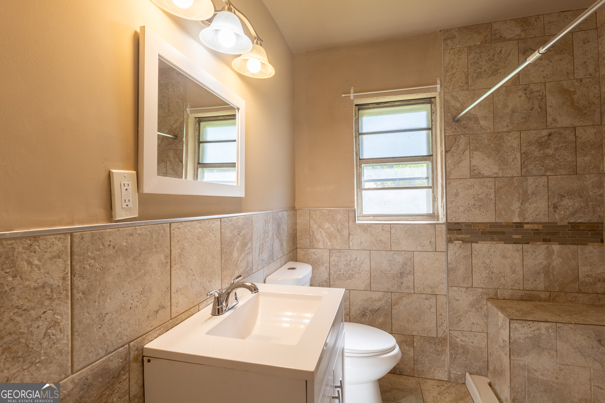 347 Peavy Street Unadilla, GA 31091 - Photo 11 of 15 a bathroom with a sink a toilet and a mirror