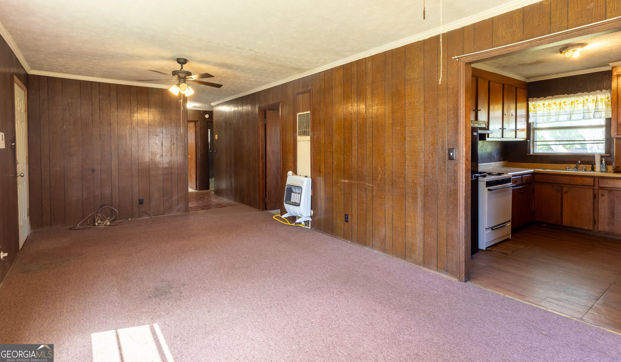 347 Peavy Street Unadilla, GA 31091 - Photo 5 of 15 a view of a livingroom with a chandelier fan and kitchen view