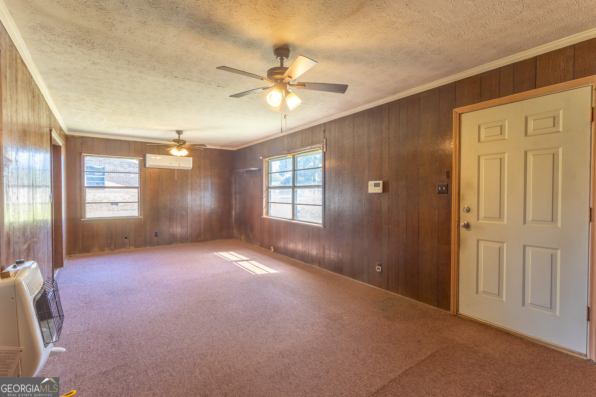 347 Peavy Street Unadilla, GA 31091 - Photo 6 of 15 an empty room with windows and fan
