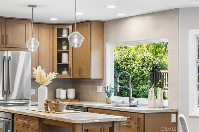 a kitchen with a sink and a large window