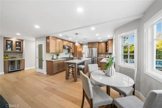 a kitchen with a dining table chairs and stove