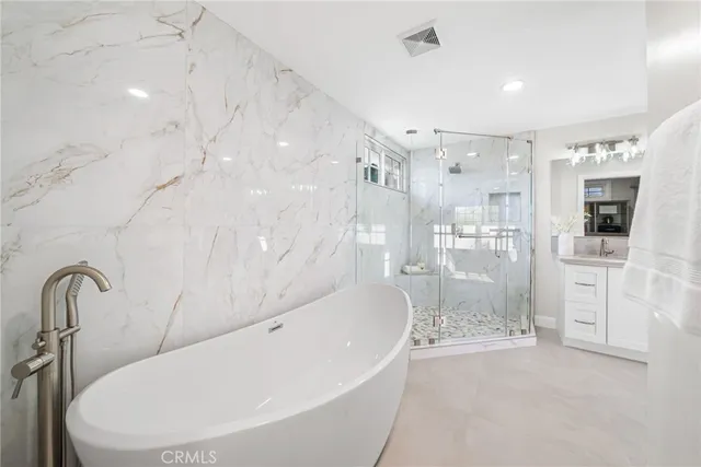 a bathroom with a bathtub and a shower