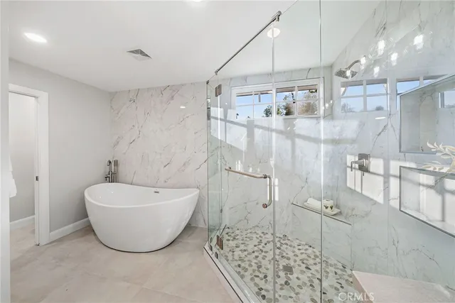 a bathroom with a bathtub and shower