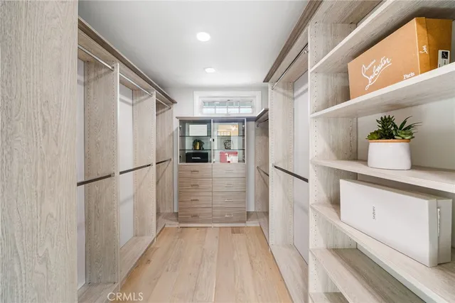 a view of walk in closet with white walls