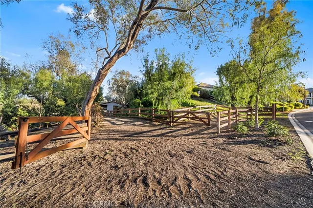 a view of a house with wooden fence