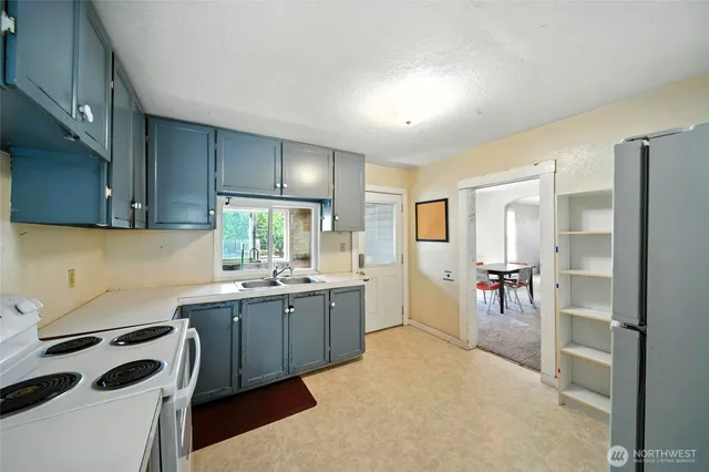 a kitchen with a sink stove and cabinets