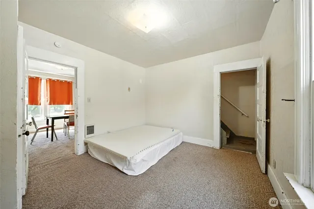 a spacious bedroom with a bed and a table in it