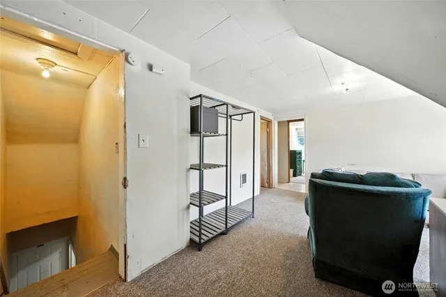 a living room with a stove and a refrigerator