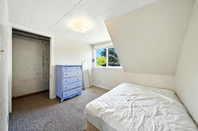 a bedroom with a bed and a dresser