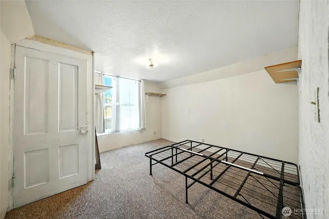 a spacious bedroom with a bed and a window