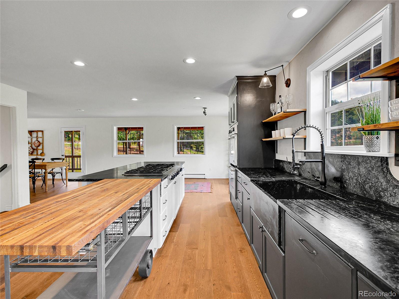 2635 Nova Road Pine, CO 80470 - Photo 12 of 45 a large kitchen with granite countertop lots of counter space and wooden floor