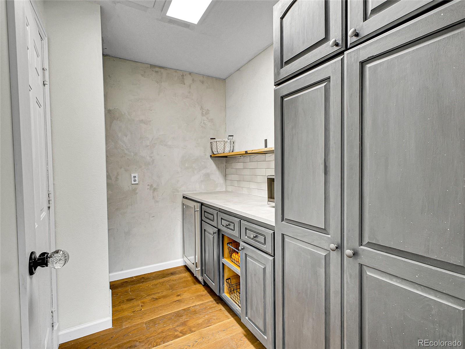 2635 Nova Road Pine, CO 80470 - Photo 19 of 45 a hallway with cabinets and wooden floor