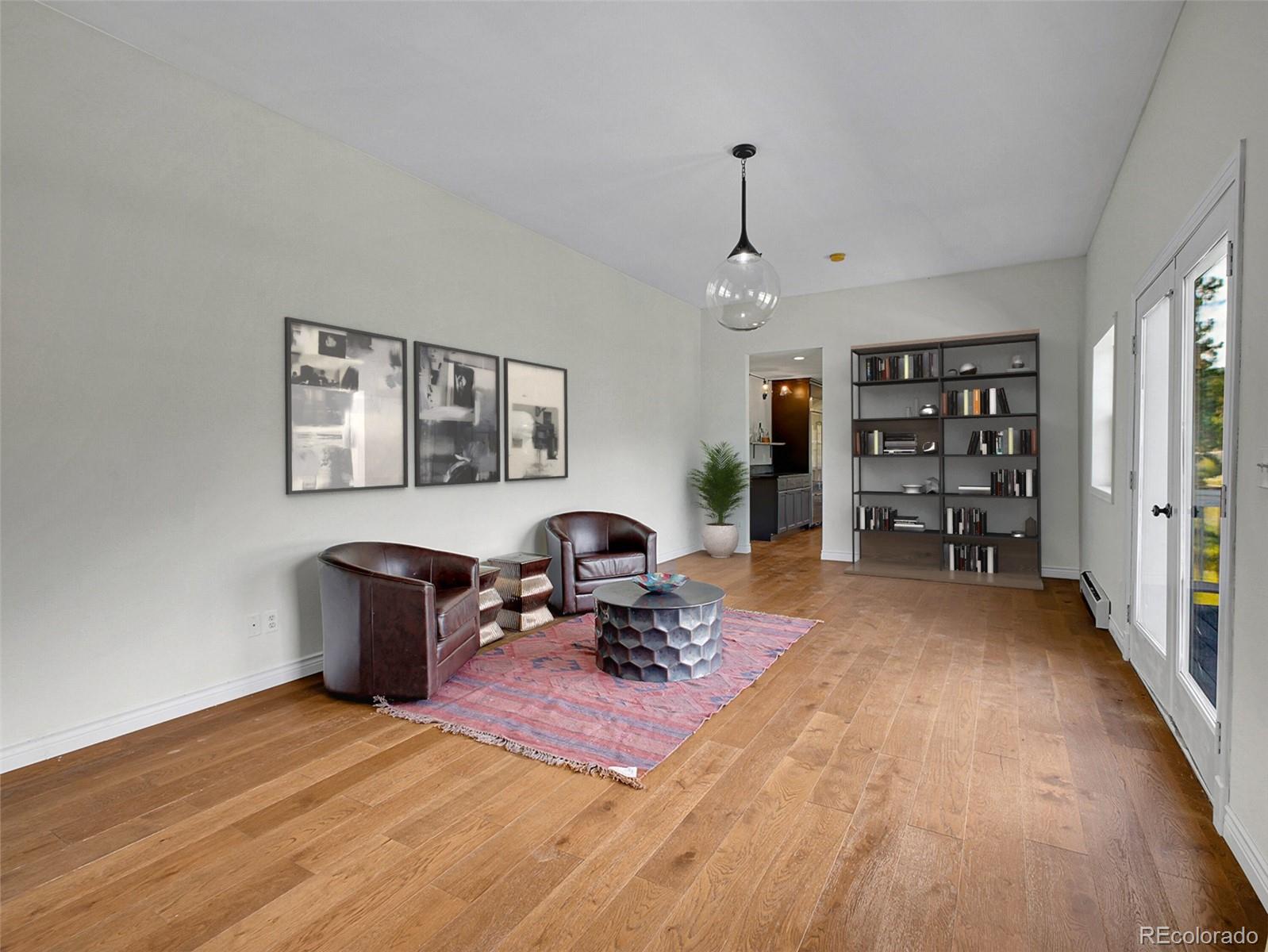 2635 Nova Road Pine, CO 80470 - Photo 20 of 45 a living room with furniture a window and a wooden floor