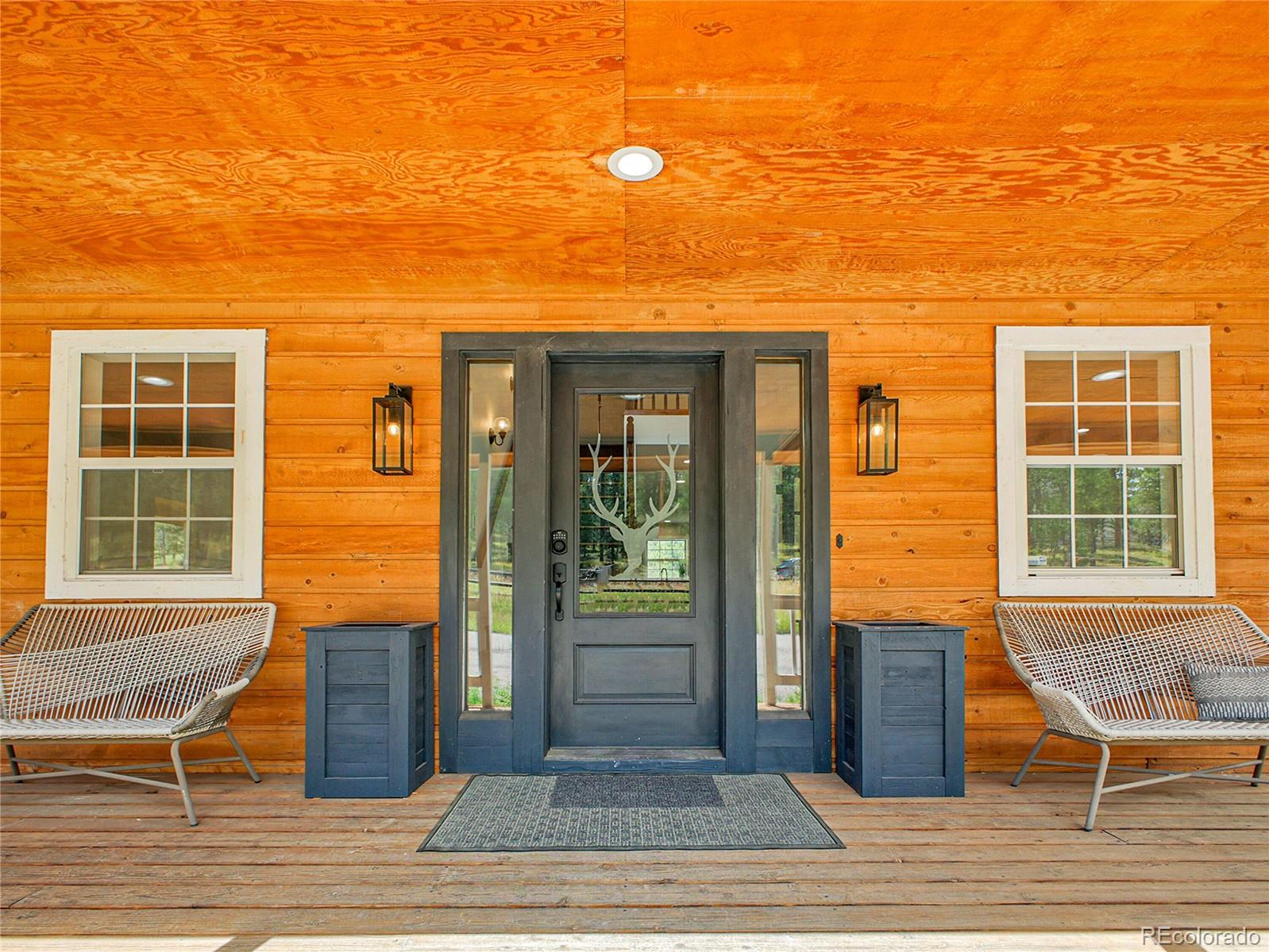 2635 Nova Road Pine, CO 80470 - Photo 2 of 45 a view of a brick house with a chairs and table