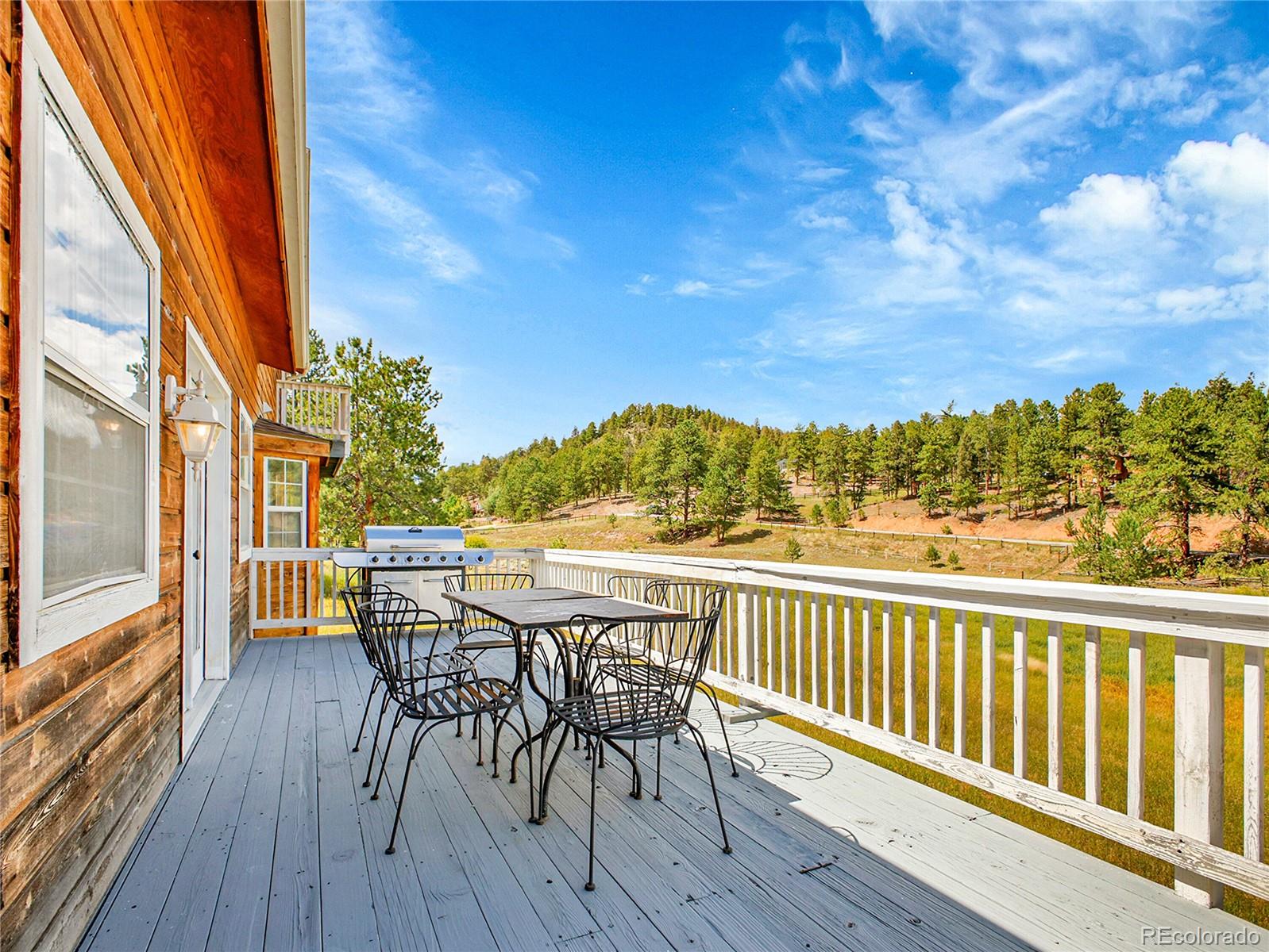 2635 Nova Road Pine, CO 80470 - Photo 22 of 45 a view of a balcony with furniture and wooden floor