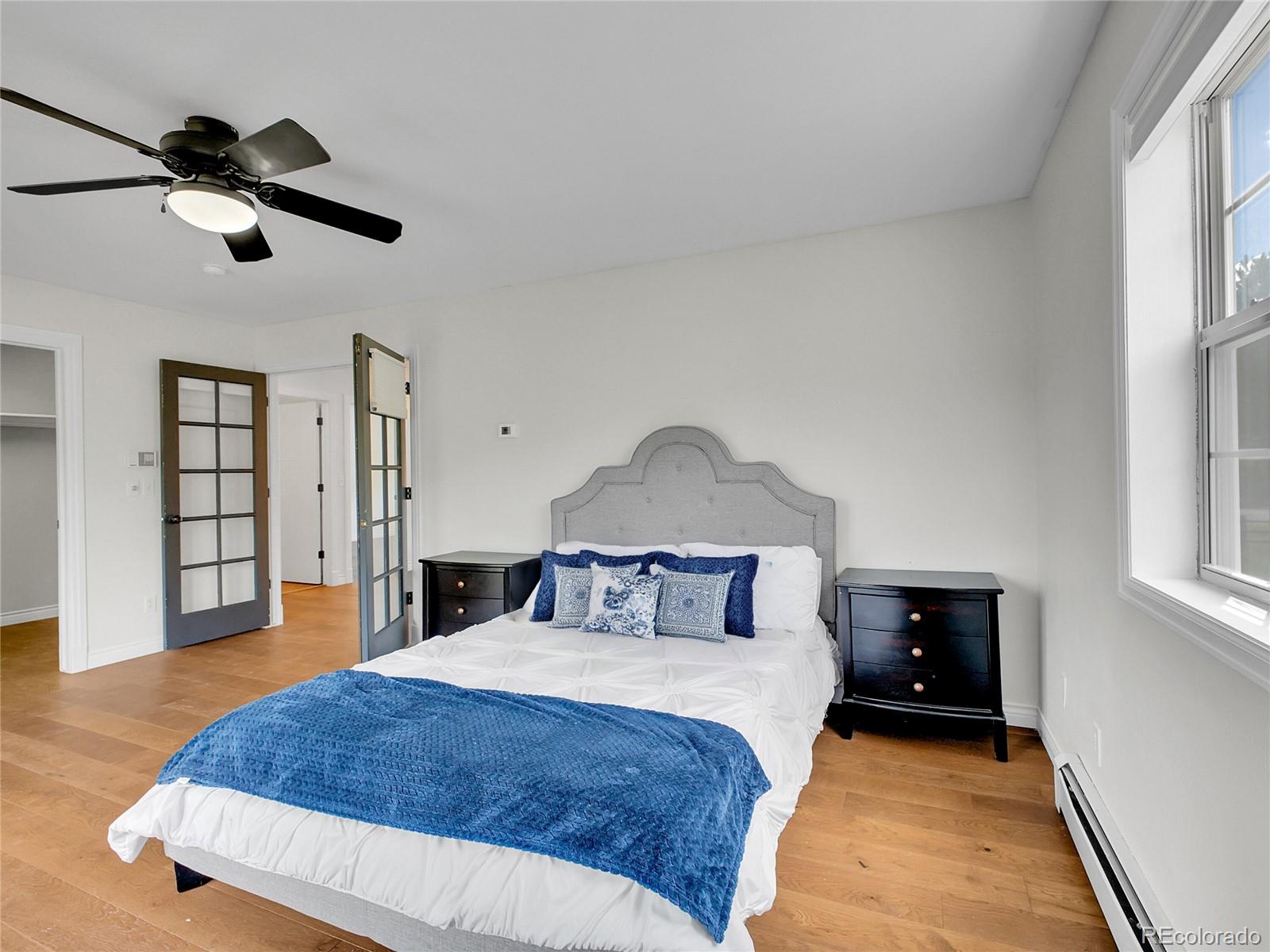 2635 Nova Road Pine, CO 80470 - Photo 28 of 45 a bedroom with a bed and a chandelier