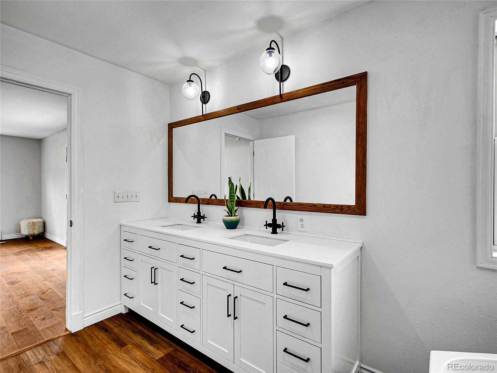 2635 Nova Road Pine, CO 80470 - Photo 32 of 45 a bathroom with a double vanity sink and mirror
