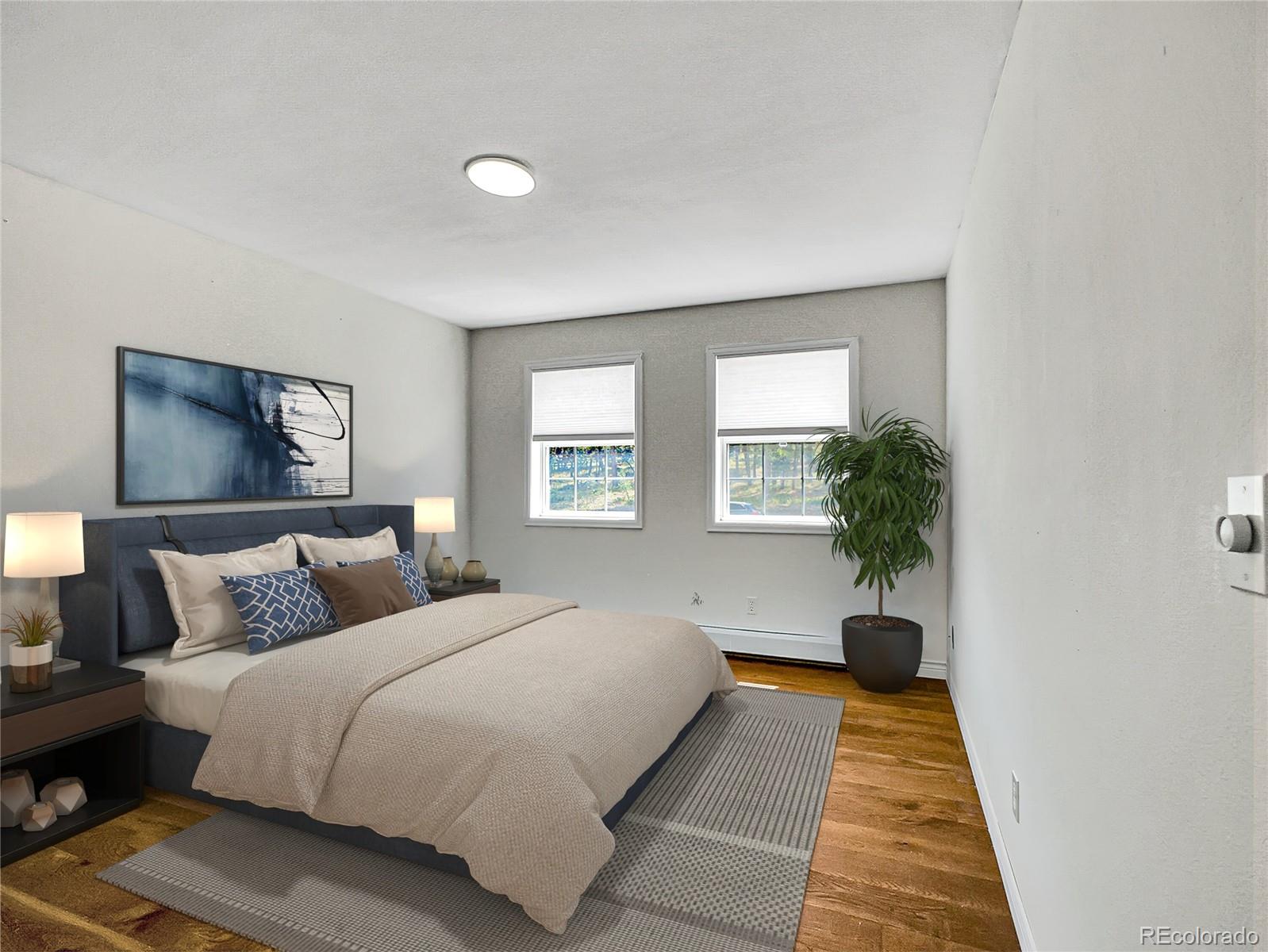 2635 Nova Road Pine, CO 80470 - Photo 34 of 45 a bedroom with a large bed and a potted plant