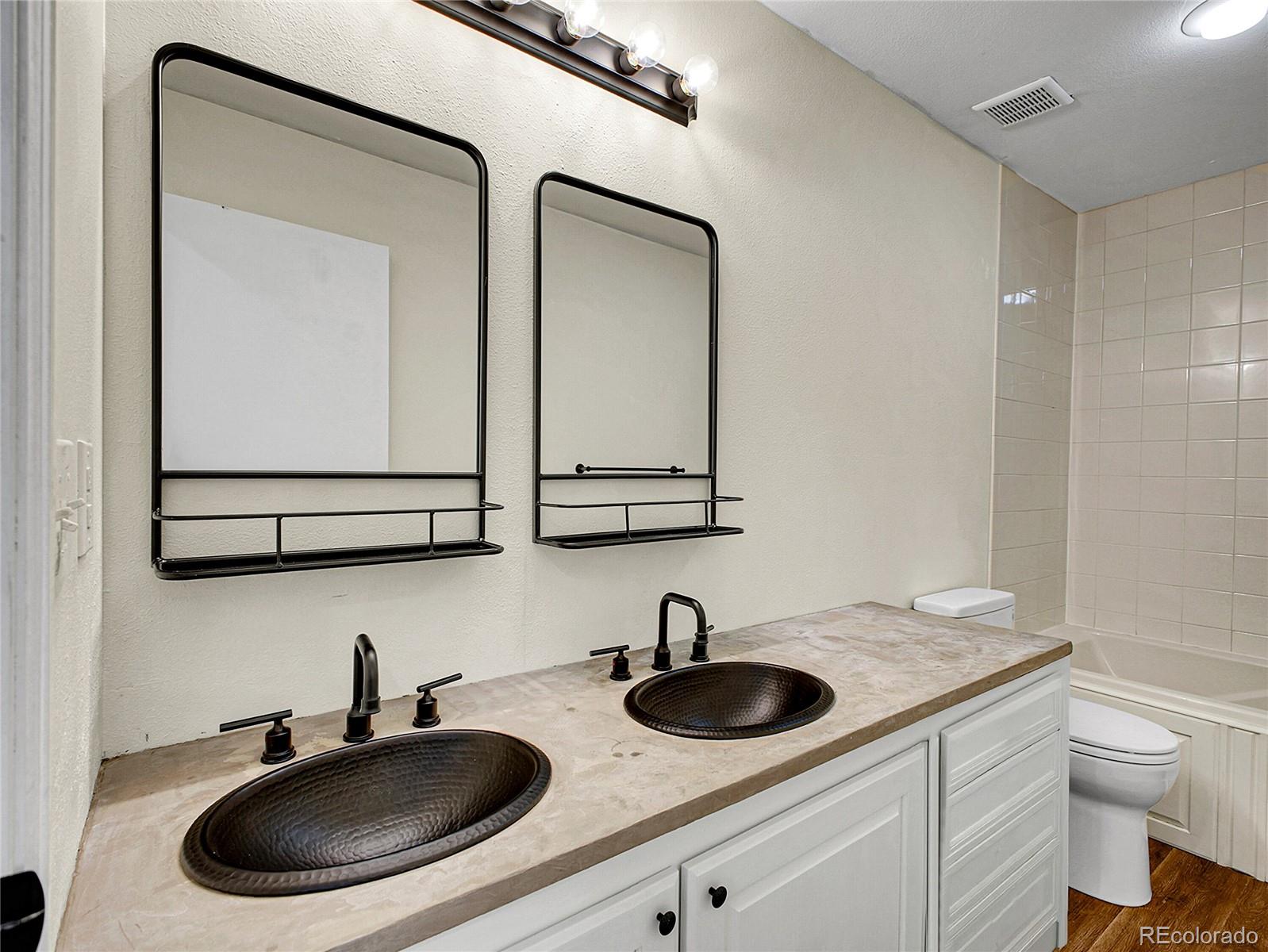 2635 Nova Road Pine, CO 80470 - Photo 35 of 45 a bathroom with a toilet a sink and mirror