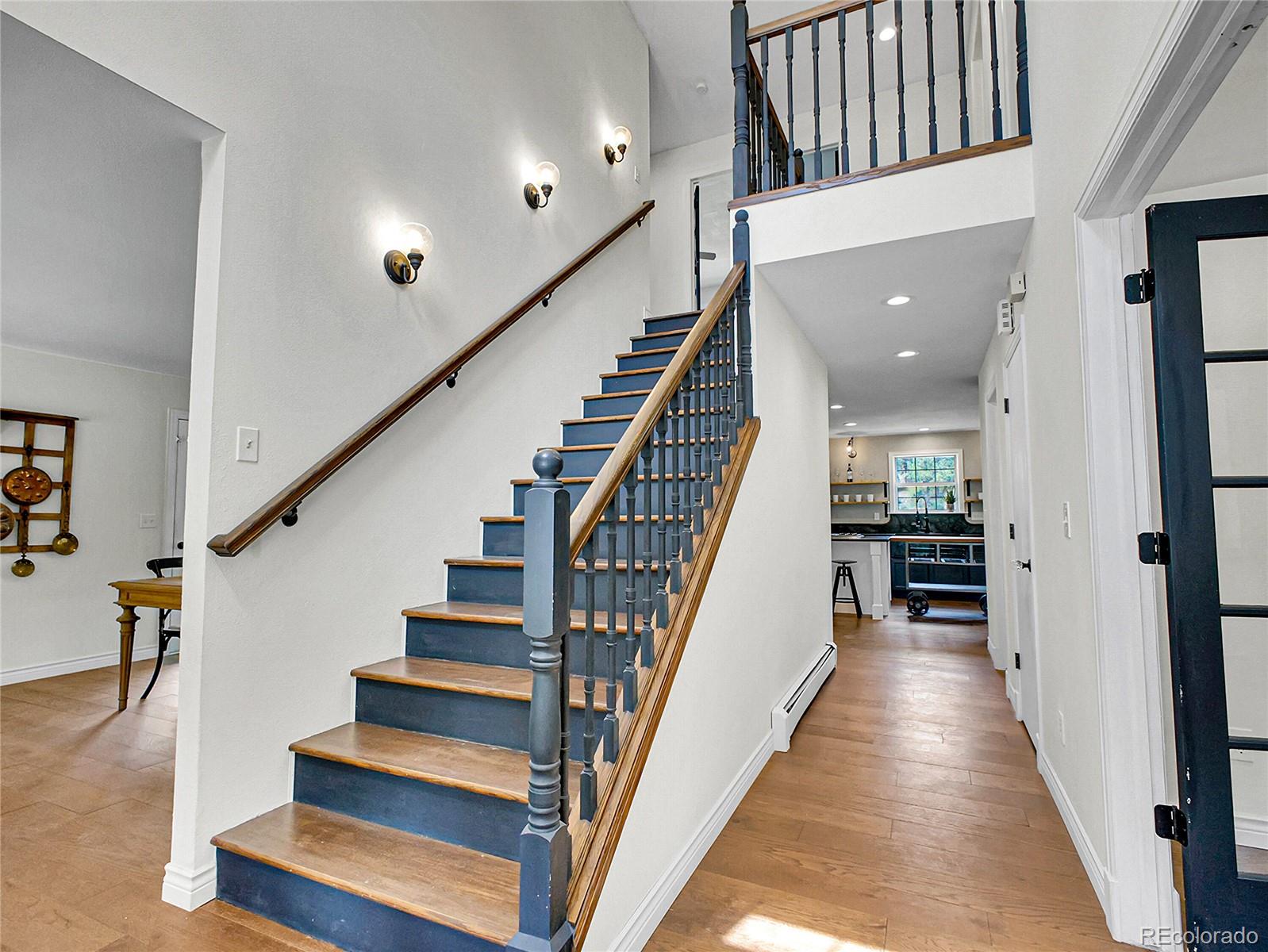 2635 Nova Road Pine, CO 80470 - Photo 4 of 45 a view of staircase with wooden floor and a rug