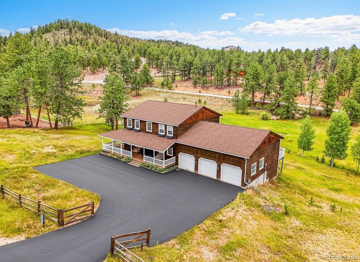 2635 Nova Road Pine, CO 80470 - Photo 44 of 45 a swimming pool with outdoor seating and yard